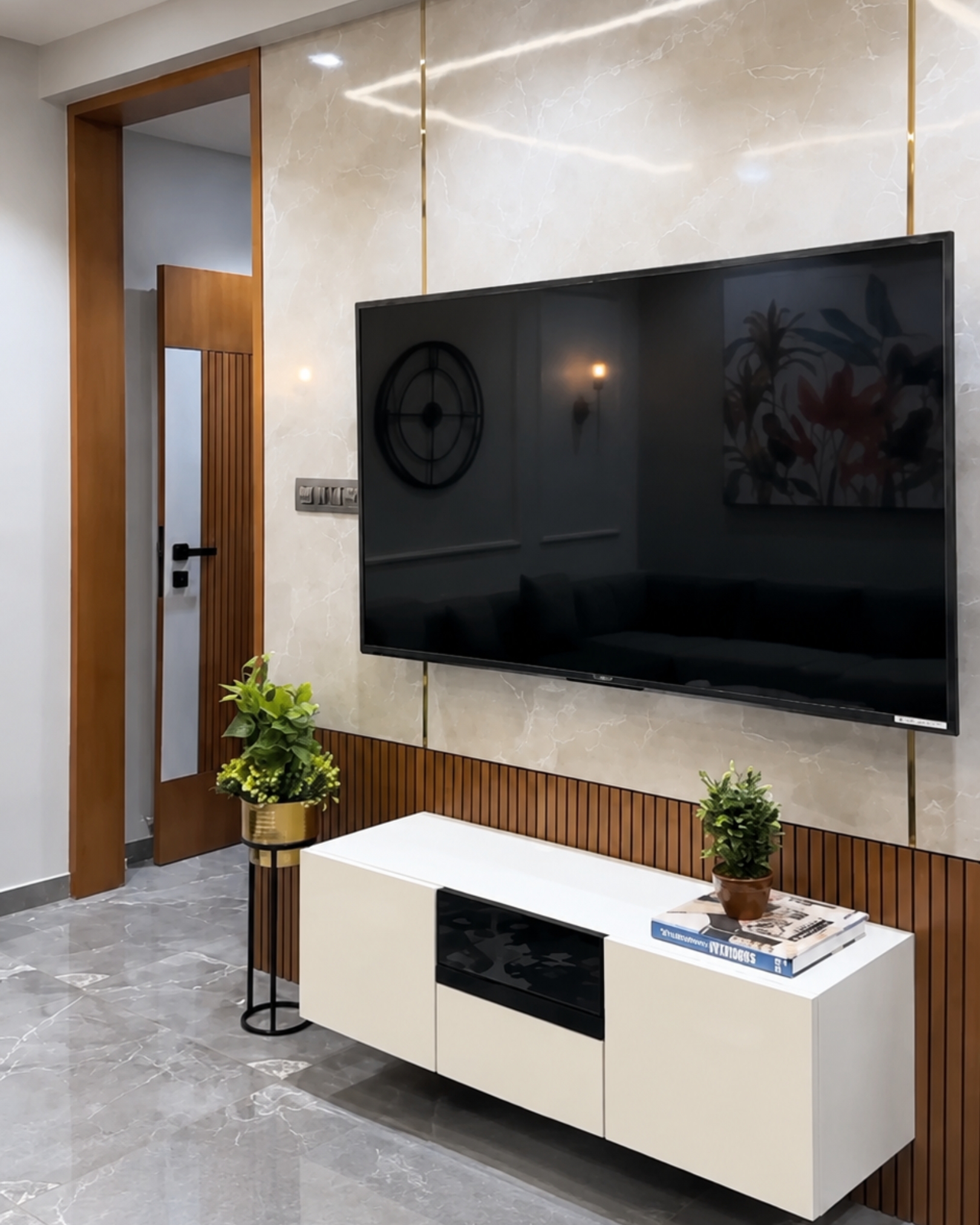 3 Cream marble effect TV wall with gold trim, wood-look slat detailing and a floating white media cabinet.