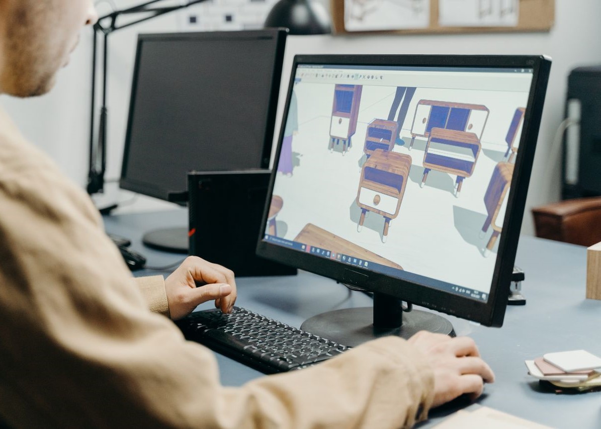 A designer using a computer for 3D furniture modeling A designer using a computer for 3D furniture modeling