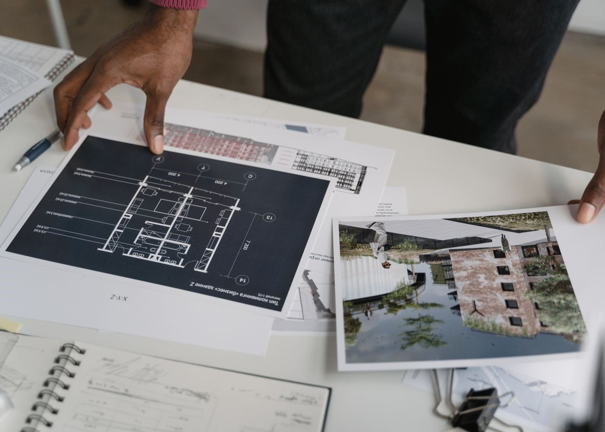 Interior designer reviewing blueprints and designs Interior designer reviewing blueprints and designs